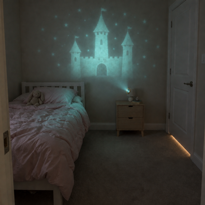After: the same bedroom with a glowing fairytale castle projected across the wall